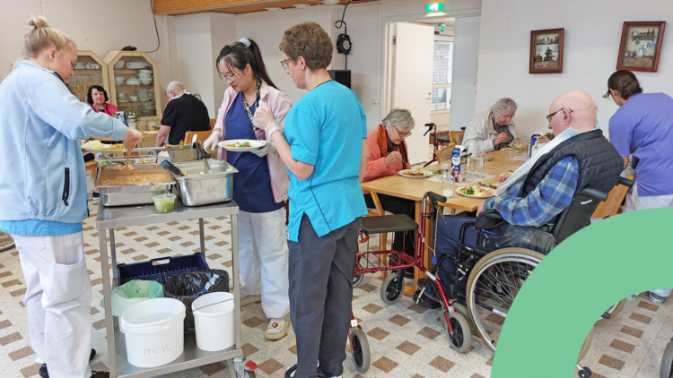 Hoitajat jakamassa ruokaa iäkkäille asumisyksikön ruokasalissa.
